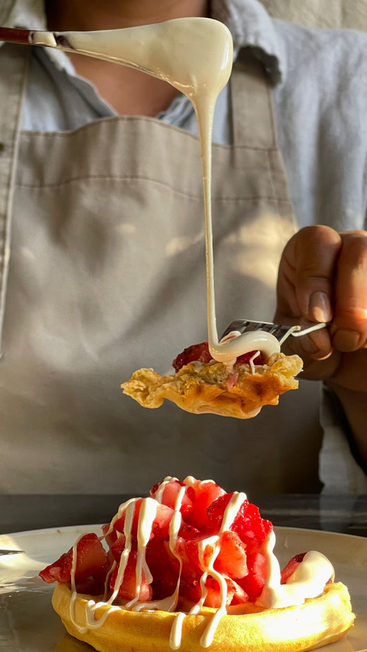Miel Cremada de Quillay servida sobre waffle con frutillas, mostrando su textura cremosa